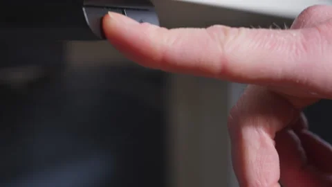 Finger Pressing Button to Raise Adjustable Standing Desk Stock Footage 328053539