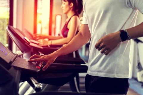 Finger pressing on button of running machine in gym Stock Photos