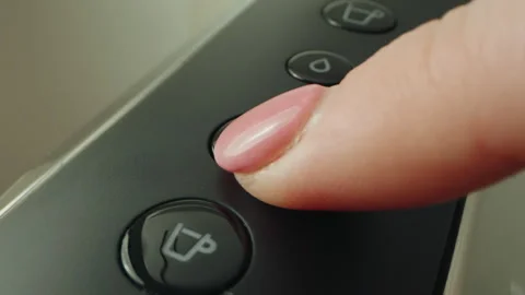 Finger pressing button to select coffee drink in a modern kitchen appliance Stock Footage 304857891