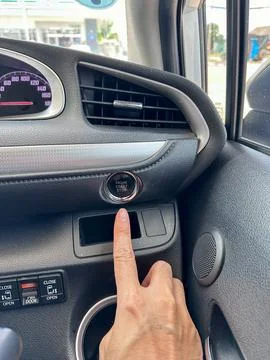 Finger pressing button the start button, stop the engine in the luxury car... Stock Photos