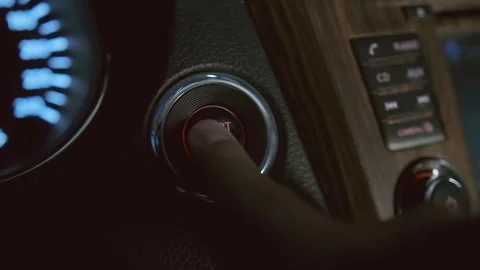 Finger pressing a button to start a car engine, side view, close up Stock Footage 246403662