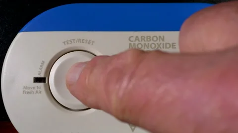 Finger pressing button to test operation of carbon monoxide alarm. Stock-Footage 162677706