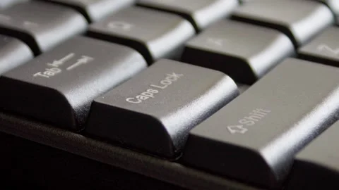 Finger pressing Caps lock on keyboard Stock Footage 331127049