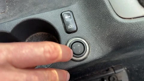 Finger pressing car cigarette lighter socket button close up, vehicle power Stock Footage 337120864
