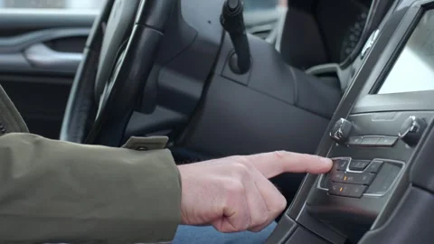 Finger pressing car climate control button on dashboard Stock-Footage 328042330