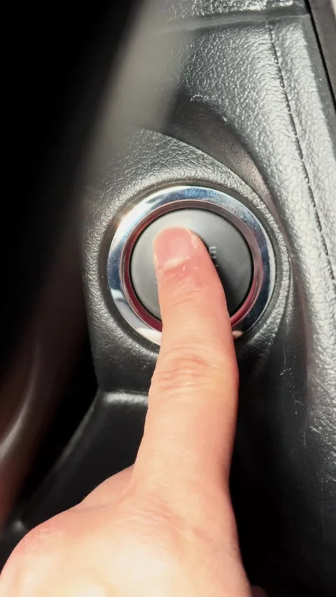 Finger pressing car engine start-stop button Stock Footage 311348246