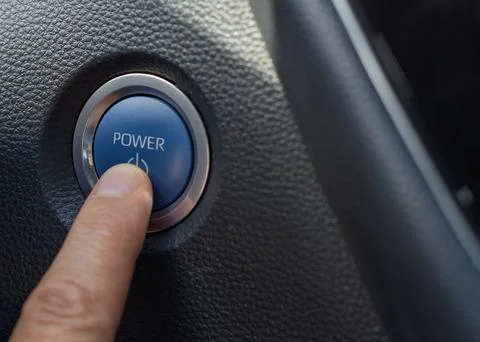 Finger pressing car engine start/stop power button Fotos de archivo