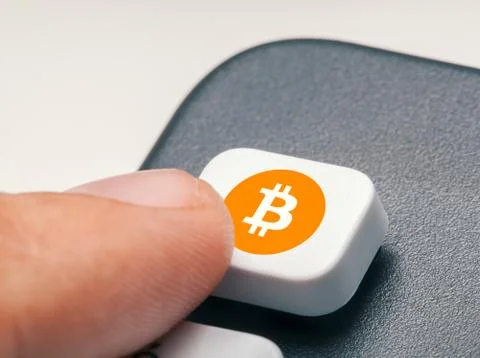Finger pressing computer key with bitcoin logo. crypto mining trading concept Illustrazione stock