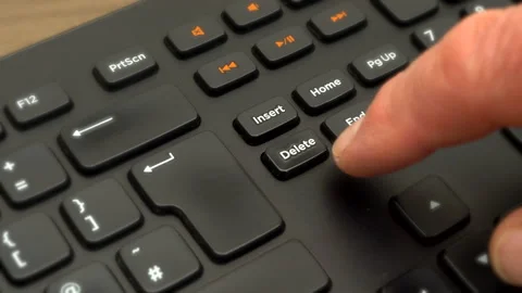 Finger pressing the Delete key numerous times on a computer keyboard. Stock-Footage 200873213