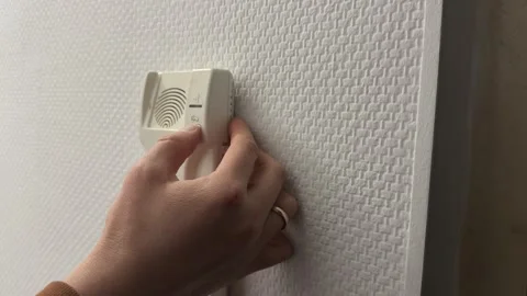 Finger pressing door unlock button on home intercom panel, apartment access Stock Footage 337120158