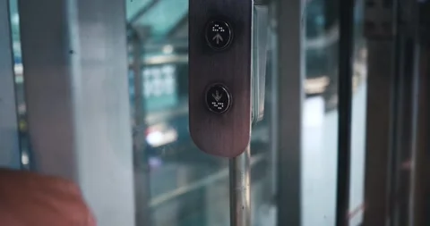 Finger Pressing Elevator Button Down in Office Center or Hotel. Mans hand Stock Footage 251698216