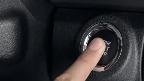 Finger pressing engine start stop button Stock Footage 104593000