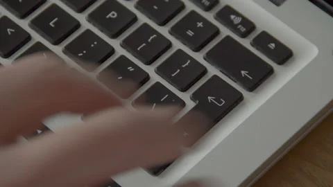 Finger pressing the Enter button on laptop keyboard multiple times Stock Footage 132320774