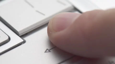 Finger pressing Enter button on a laptop keyboard Stock Footage 302909053
