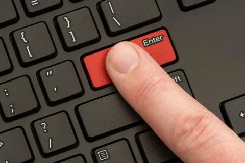 Finger pressing the ENTER button Stock Photos