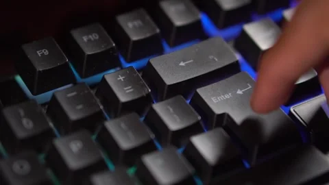 Finger pressing Enter key on backlit keyboard Stock Footage 277145534