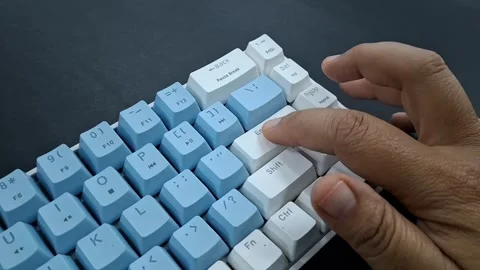 Finger pressing Enter Key on blue and white mechanical keyboard. Stock Footage 328271274