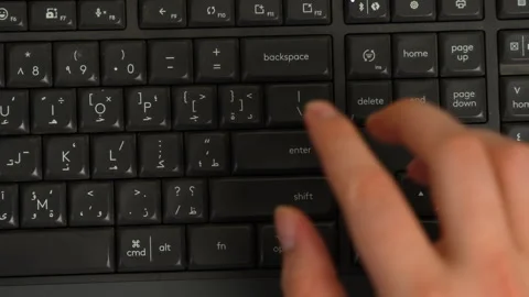 Finger pressing Enter key on computer keyboard Stock Footage 316233711