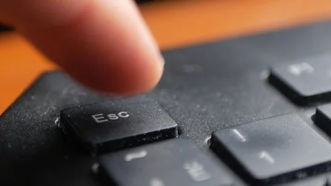 Finger pressing Esc button on computer keyboard Stock Footage 106932671