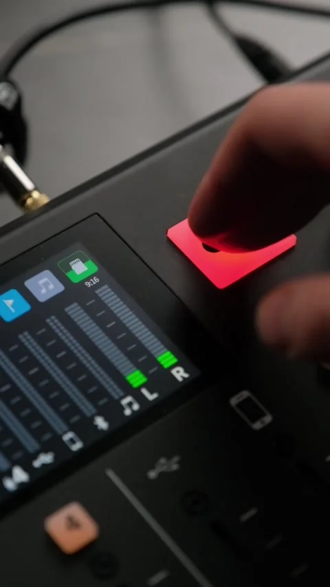 Finger pressing green mic button on audio mixer Stock Footage 306779772