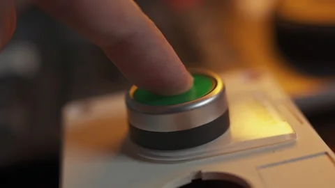 Finger Pressing Green Start Button to Activate Industrial System Stock Footage 330255640