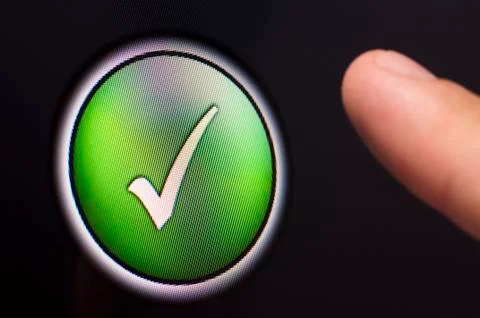 Finger pressing a green tick button on touchscreen Stock Illustration