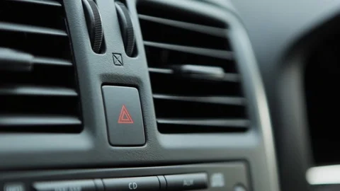 Finger is pressing the hazard light button Stock Footage 86957996