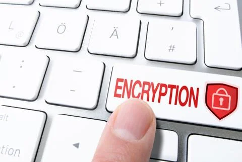 Finger pressing key on computer keyboard labeled ENCRYPTION with padlock on Stock Photos