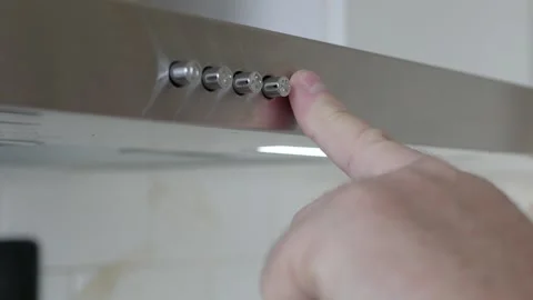 Finger Pressing Kitchen Range Hood Power Button Closeup. Man Pressing Stainless Stock Footage 336916551