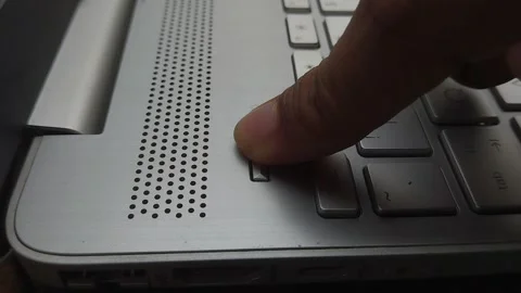 Finger Pressing Laptop Power Button to Start or Shut Down Computer Stock Footage 310937691