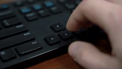 Finger Pressing Left Arrow Key on Black Computer Keyboard Close Up Stock Footage 323399157