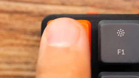 Finger Pressing Orange Escape Button Key on Mechanical Gaming Desktop Computer Stock Footage 234400009