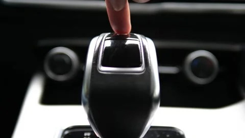 Finger pressing on the parking position on the automatic transmission of the car Stock-Footage 312869787