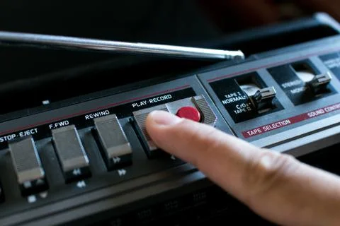 Finger pressing the Play button on an old stereo 80's Stock Photos