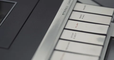 Finger pressing PLAY button on retro audio cassette tape player recorder Stock Footage 121188182