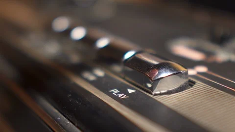 Finger is pressing a PLAY button on vintage audiorecorder closeup macro view Video stock 111439628