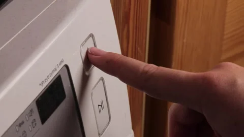 Finger pressing power button on washing machine, start of clean cycle captu.. Stock Footage 319825654