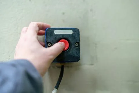 Finger pressing red button on old device Stock Photos