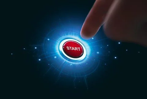 Finger pressing red start button on dark background 写真素材