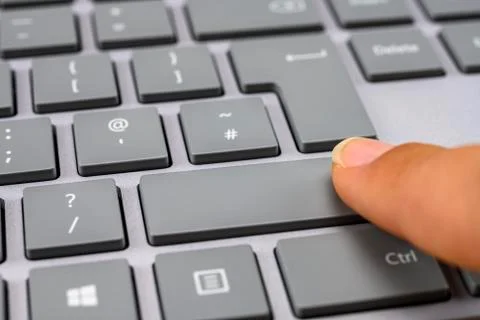 Finger pressing the shift key on keyboard Stock Photos