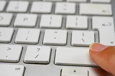 Finger pressing the shift key on keyboard Stock Photos