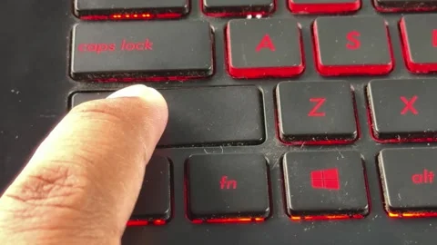 Finger pressing "shift" keys on backlit laptop keyboard, Stock Footage 334117559