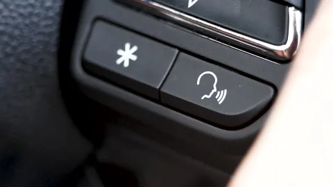 Finger pressing the smart system button voice control (i-SMART)on the steering. Stock Footage 137773025