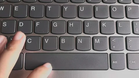 Finger pressing space bar button on the laptop computer's keyboard Stock Footage 285923551