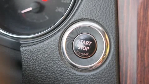 Finger pressing start button close-up shot on car dashboard with ignition Stock Footage 333649368