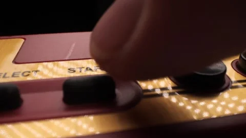 Finger pressing start button on retro game console Stock Footage 315810195