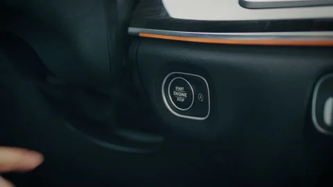 Finger pressing start stop engine button in car Stock Footage 146797756