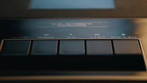 Finger pressing stop button on vintage cassette player in dark room closeup. Video stock 332617028