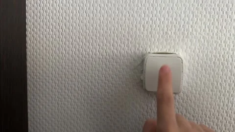 Finger pressing wall switch button, turning home electrical control on or off 動画素材 337119857