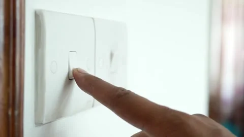 Finger pressing white light switch on wall at home indoor in close up cinem.. Stock Footage 332473033